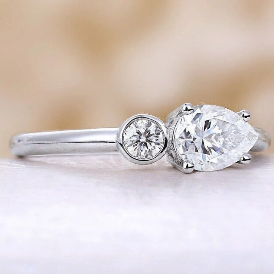 /public/photos/live/East West Pear With Round Cut 2 Stone Moissanite Ring 645 (2).webp